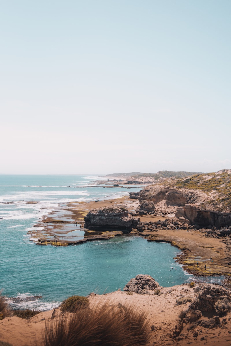 brown rock formation on sea during daytime